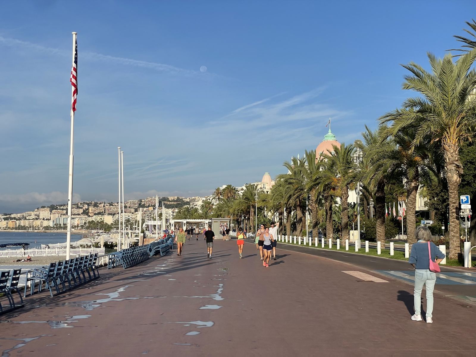 Promenade des Anglais — palm trees, morning light, people walking, the long Nice seafront